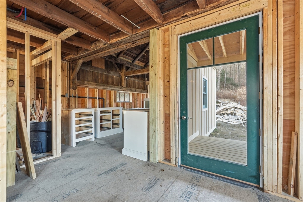63 Cooleyville Road New Salem, MA 01355 - Photo 9 of 39 a view of a hallway with wooden walls and door