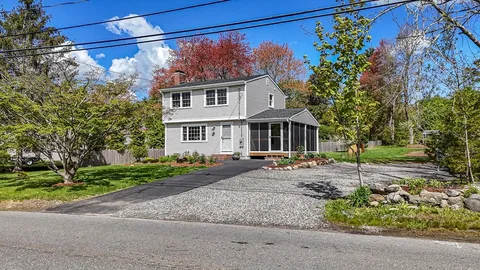 a view of a house with a tree in the yard