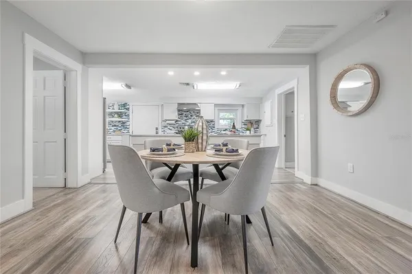 a view of a dining room with furniture and wooden floor