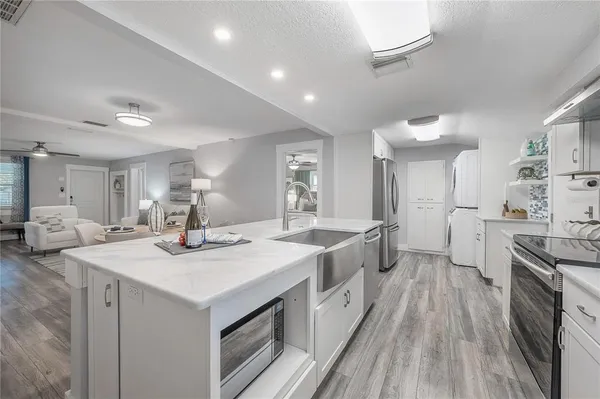 a kitchen with sink stove and refrigerator