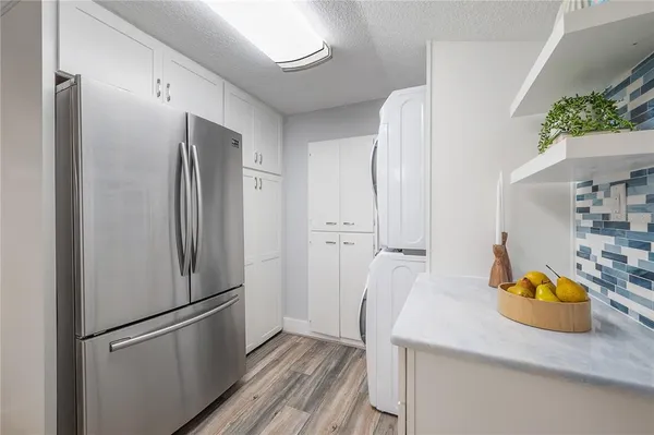 a kitchen with stainless steel appliances a refrigerator and a sink