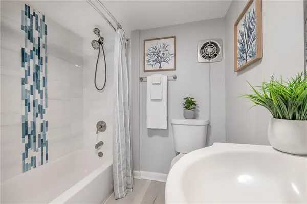 a bathroom with a bathtub a shower and a sink