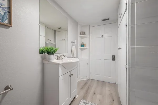 a bathroom with a sink a mirror and a shower