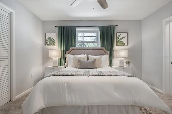 a bedroom with a large bed and a window