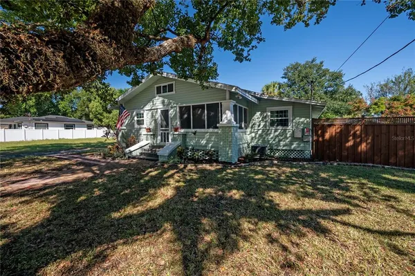 a front view of house with a garden