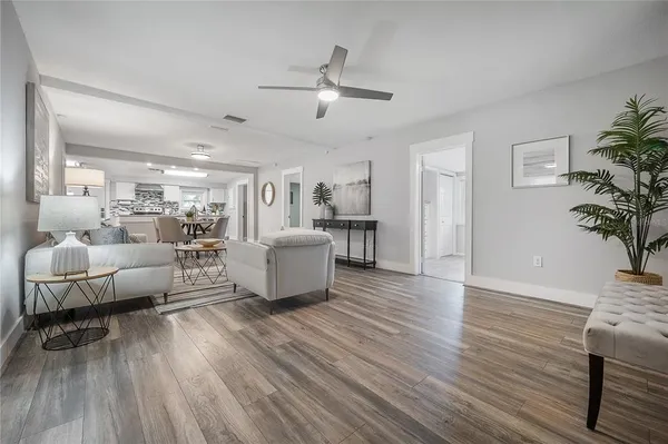 a living room with furniture and a wooden floor