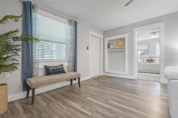 a living room with furniture and a wooden floor