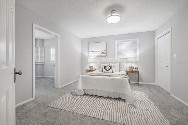 a view of a bedroom with a bed and cabinet
