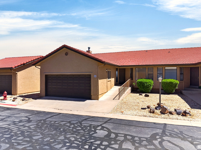161 West 950 South, Unit Q1 St. George, UT 84770 - Photo 1 of 37 View of front of property featuring a tile roof, stucco siding, a garage, and driveway
