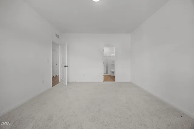 a view of an empty room with windows