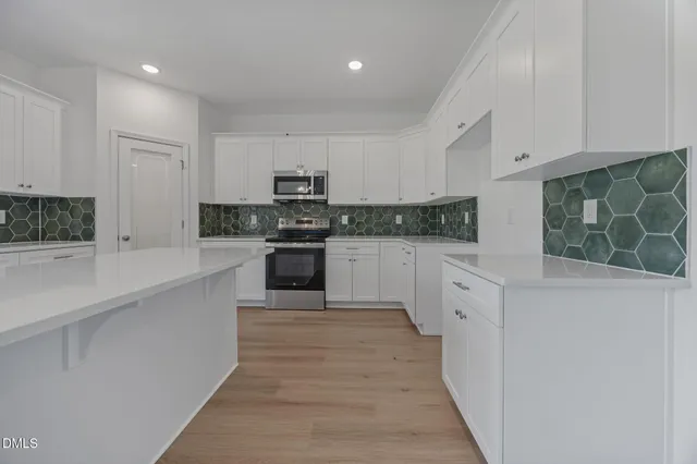 a view of kitchen with refrigerator and window