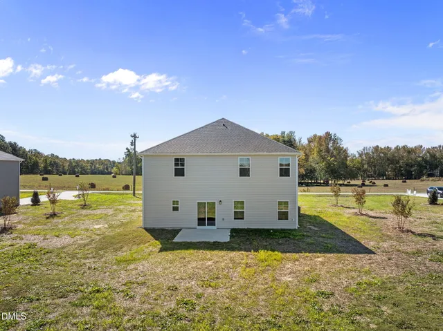 a view of a house with yard and lake view