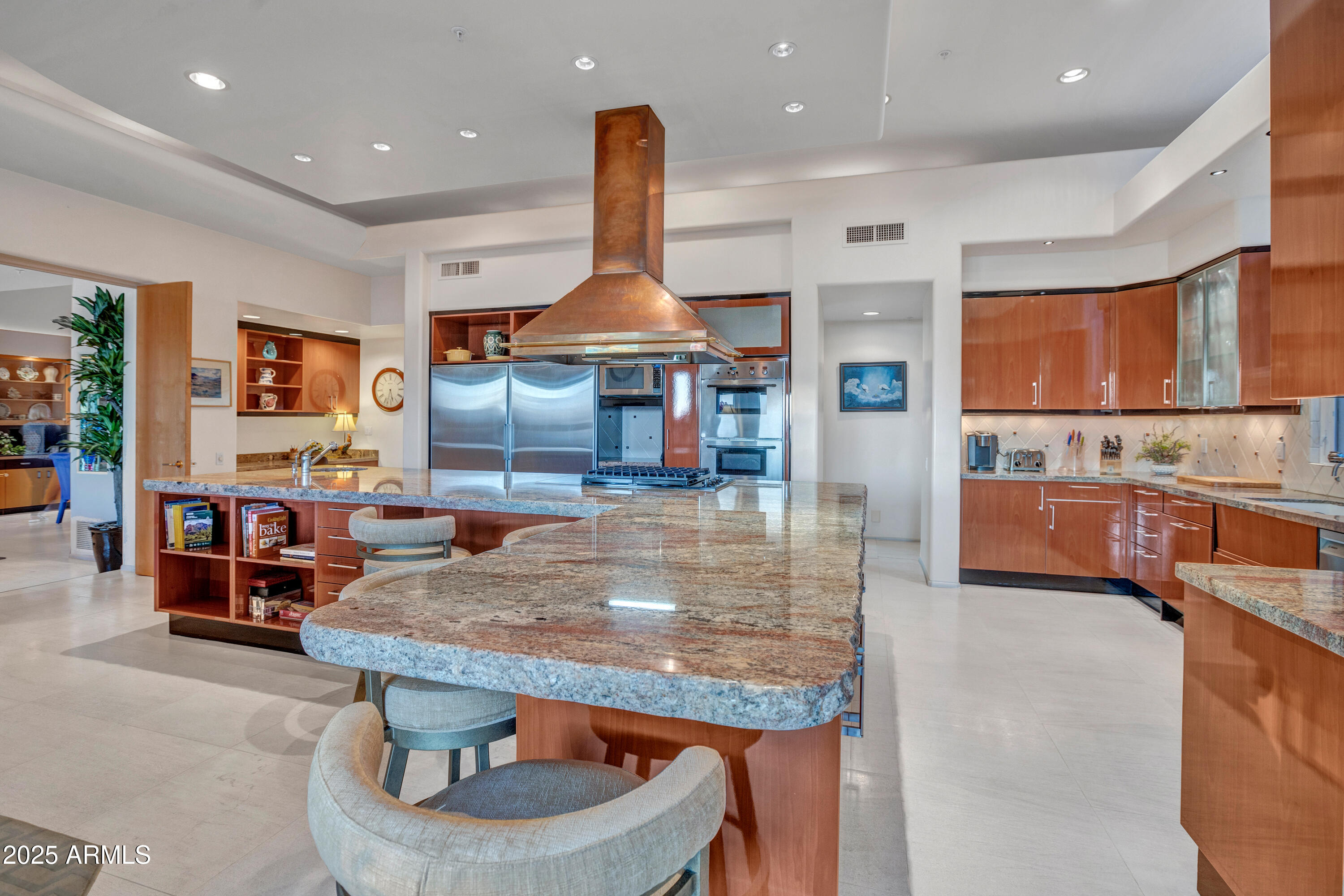 10040 East Happy Valley Road, Unit 595 Scottsdale, AZ 85255 - Photo 14 of 48 a kitchen with stainless steel appliances kitchen island granite countertop a table chairs and a refrigerator