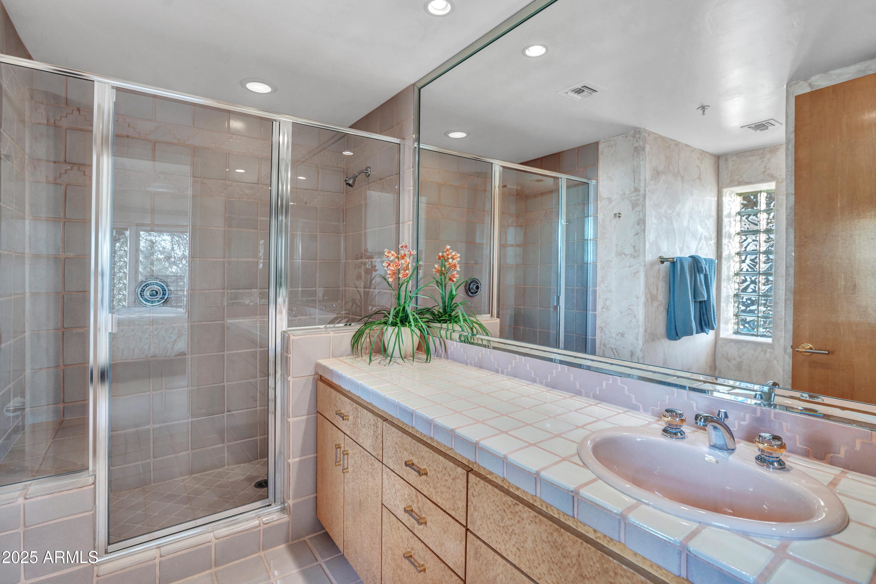 10040 East Happy Valley Road, Unit 595 Scottsdale, AZ 85255 - Photo 30 of 48 a bathroom with a shower sink and mirror