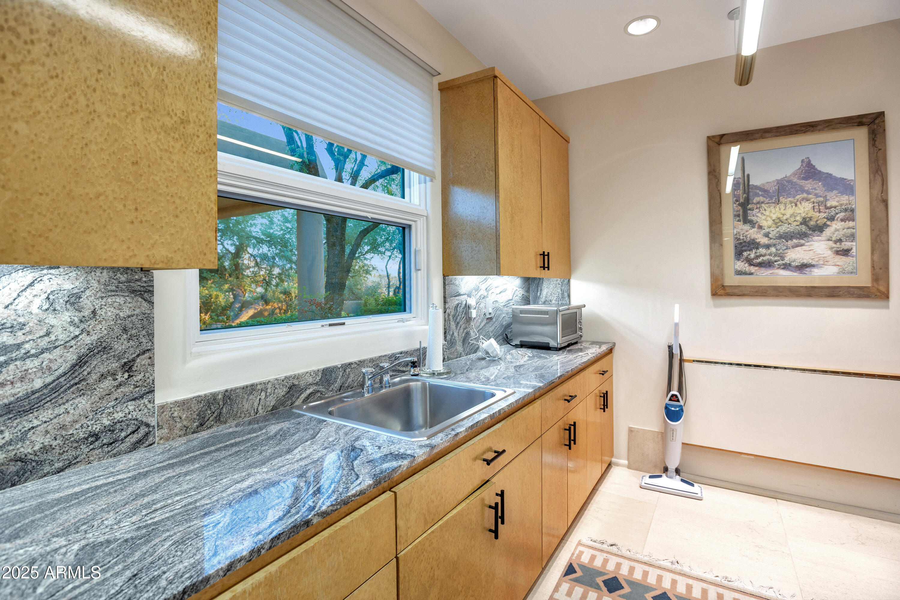 10040 East Happy Valley Road, Unit 595 Scottsdale, AZ 85255 - Photo 35 of 48 a kitchen with granite countertop a sink and a window