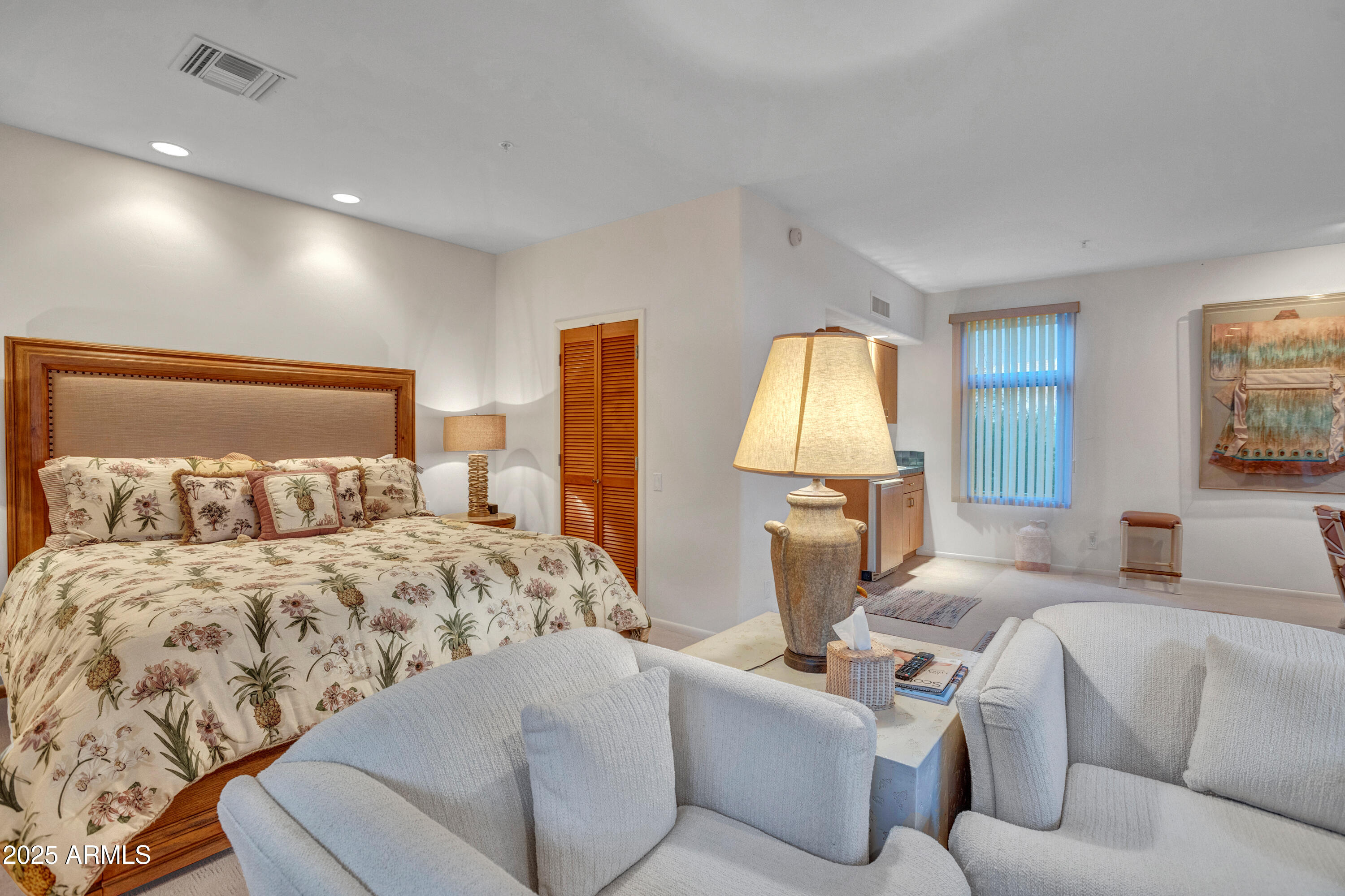 10040 East Happy Valley Road, Unit 595 Scottsdale, AZ 85255 - Photo 41 of 48 a bedroom with a large bed and a couch
