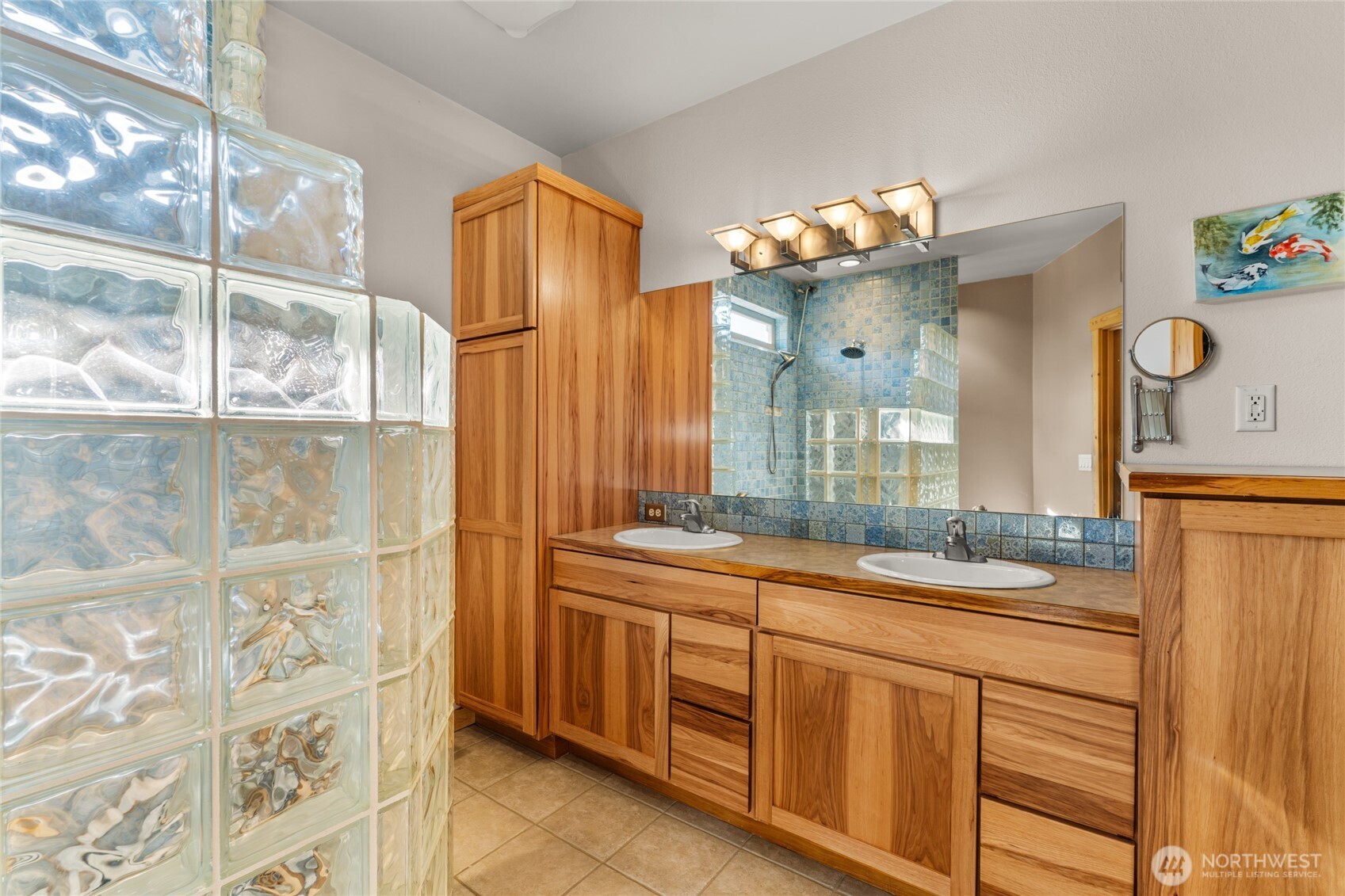 3765 Lovell Road Wenatchee, WA 98801 - Photo 16 of 40 a bathroom with a sink mirror and a shower