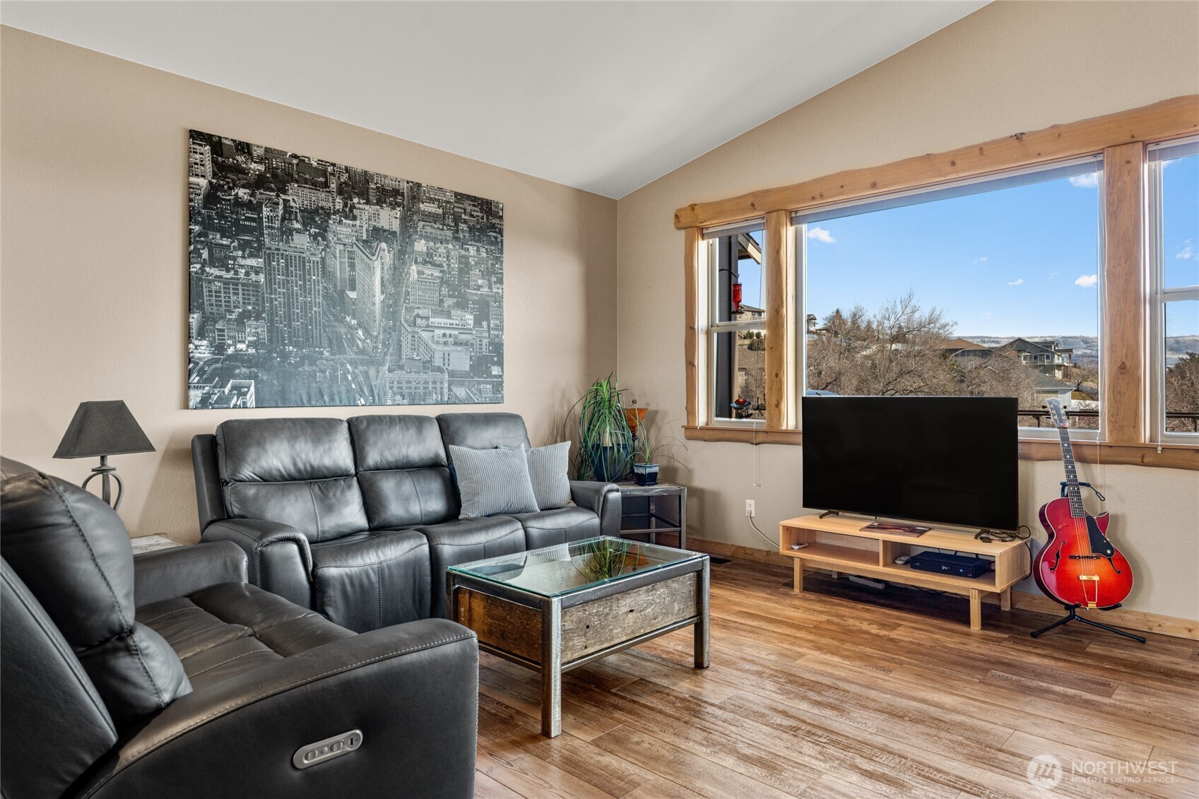 3765 Lovell Road Wenatchee, WA 98801 - Photo 7 of 40 a living room with furniture a flat screen tv and a floor to ceiling window