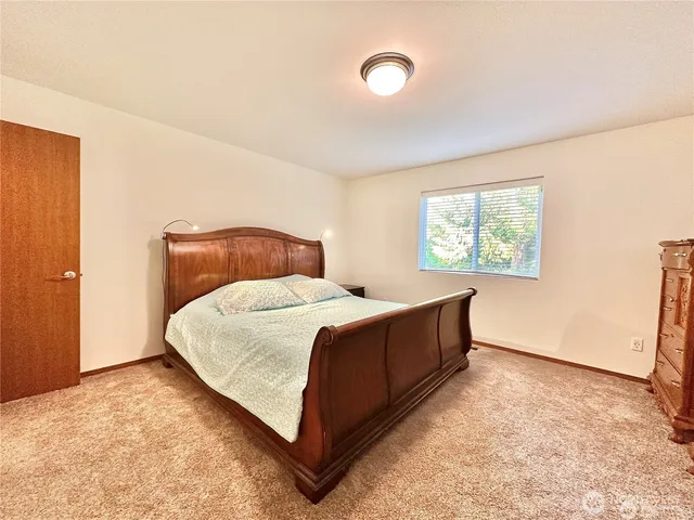 a bed room with a bed and a window