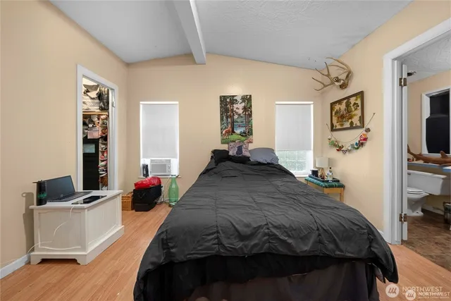 a bedroom with a bed a couch and dresser