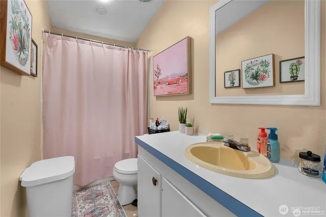 a bathroom with a sink toilet and a mirror