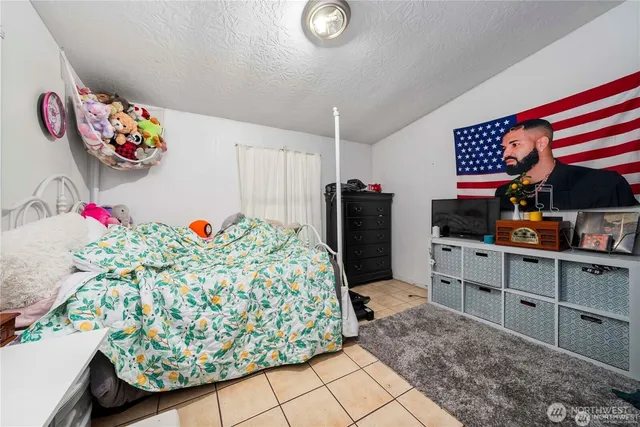 a bedroom with a bed and a dresser in it