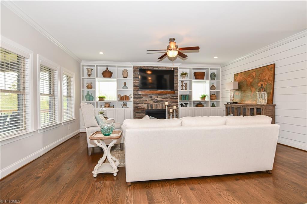 7434 Princess Ann Court Rural Hall, NC 27045 - Photo 7 of 30 Great room with stone FP, Shiplap walls, builtins, and gorgeous hardwood floors.