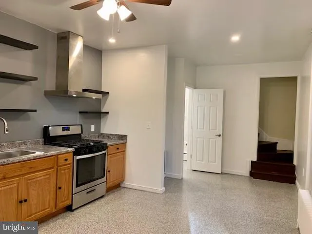 a kitchen with stainless steel appliances a stove a sink and a refrigerator