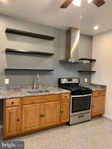 a kitchen with stainless steel appliances granite countertop a stove and a sink