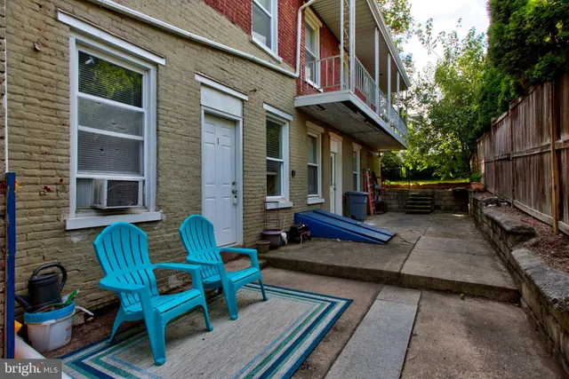 a view of a patio with chairs and a potted plant