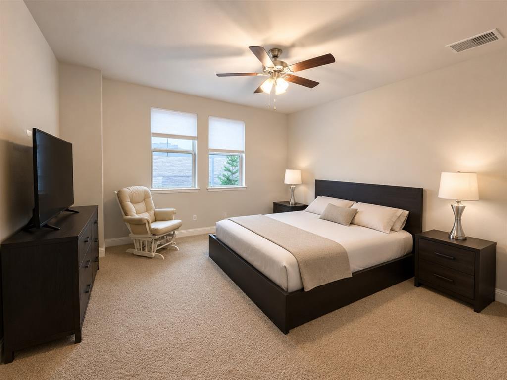 8235 Snapdragon Way Dallas, TX 75252 - Photo 15 of 29 Carpeted room featuring two windows with blinds, a ceiling fan with integrated lighting, and neutral wall tones