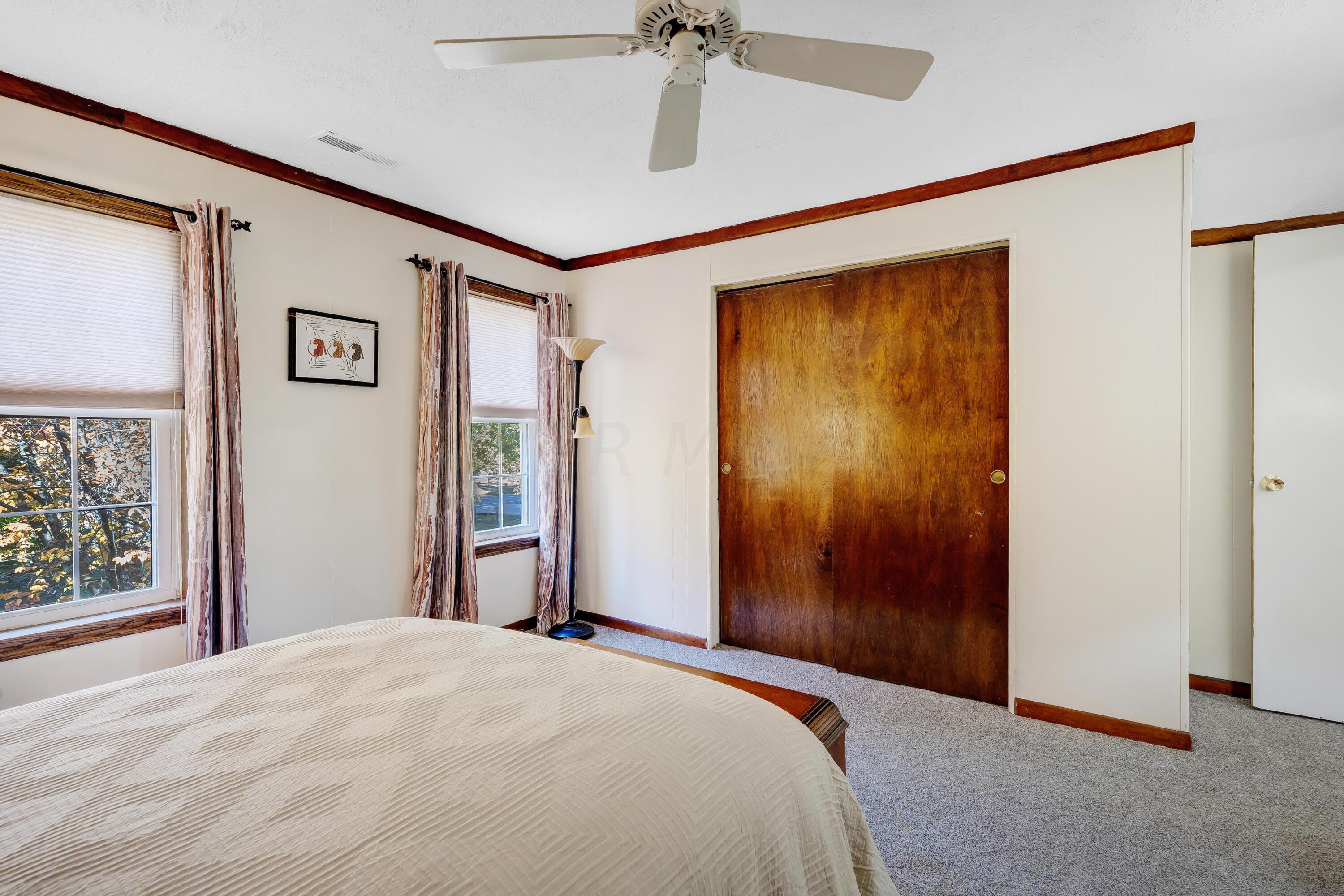6681 Harlem Road Westerville, OH 43082 - Photo 36 of 78 • New tan carpet ~ 2022 • Painted walls • Ceiling fan • Closet with double sliding doors • Shades remain • Drapes do not remain