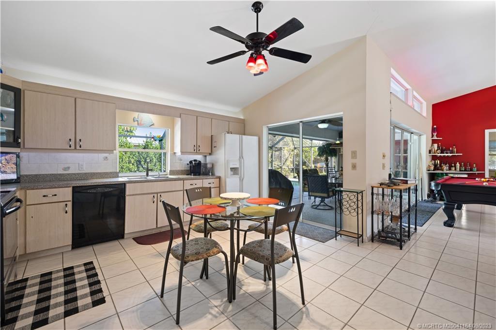5279 Southeast Horseshoe Point Road Stuart, FL 34997 - Photo 6 of 34 a kitchen with a dining table chairs and white appliances