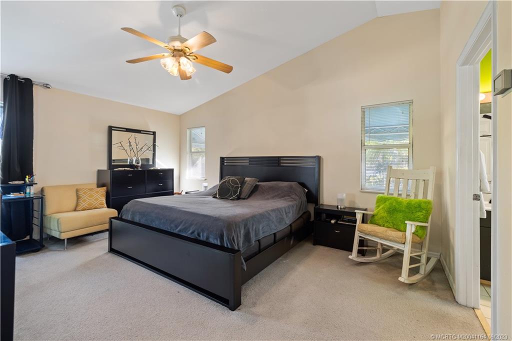 5279 Southeast Horseshoe Point Road Stuart, FL 34997 - Photo 8 of 34 a bedroom with a bed chair and a couch