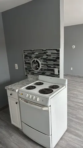 a view of a closet with wooden floor
