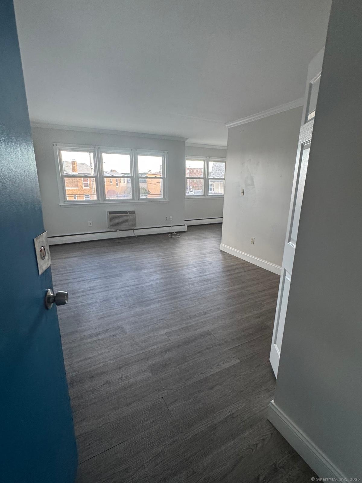 191 Oak Street, Unit B6 Bridgeport, CT 06604 - Photo 5 of 15 wooden floor in an empty room with a window
