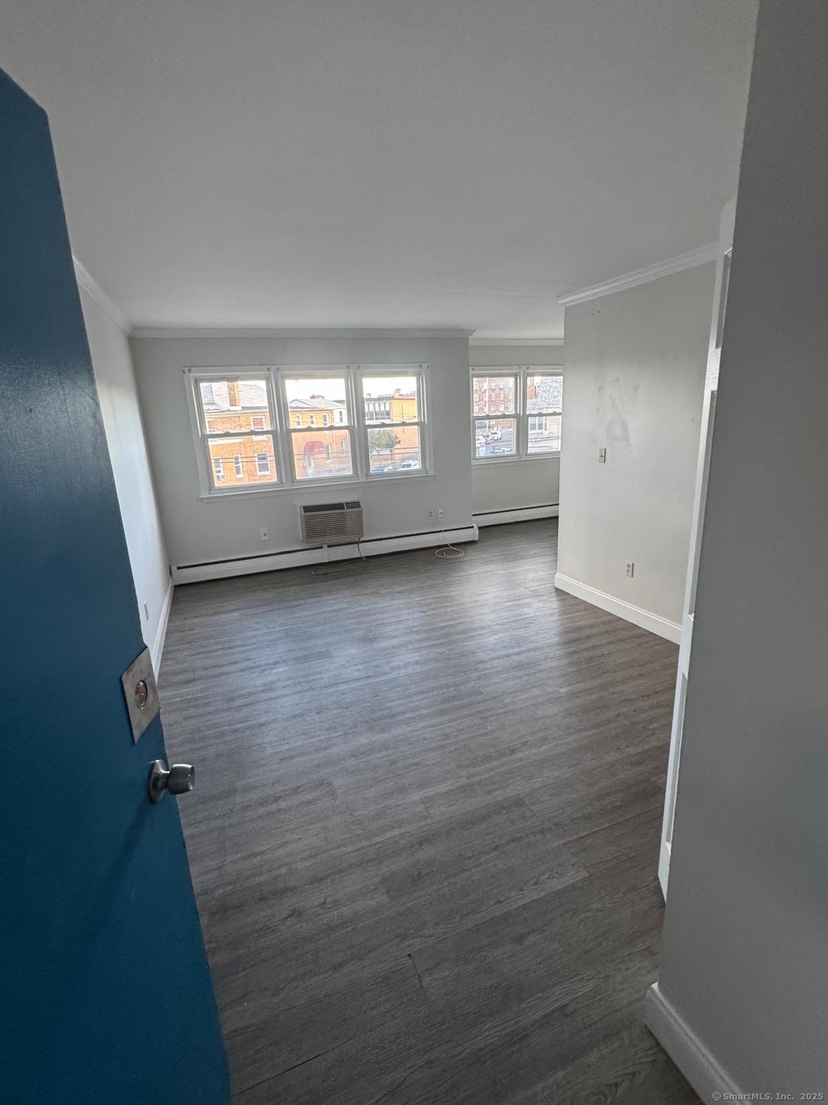 191 Oak Street, Unit B6 Bridgeport, CT 06604 - Photo 6 of 15 wooden floor in an empty room with a window