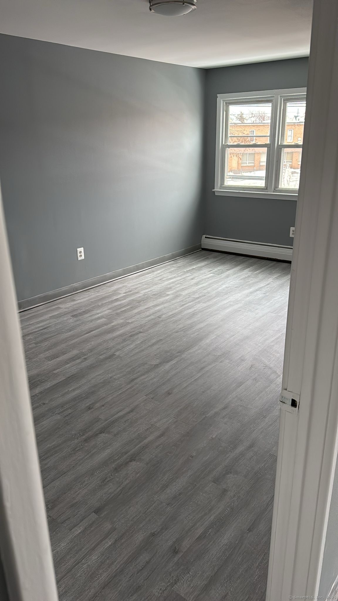 191 Oak Street, Unit B6 Bridgeport, CT 06604 - Photo 7 of 15 wooden floor in an empty room with a window
