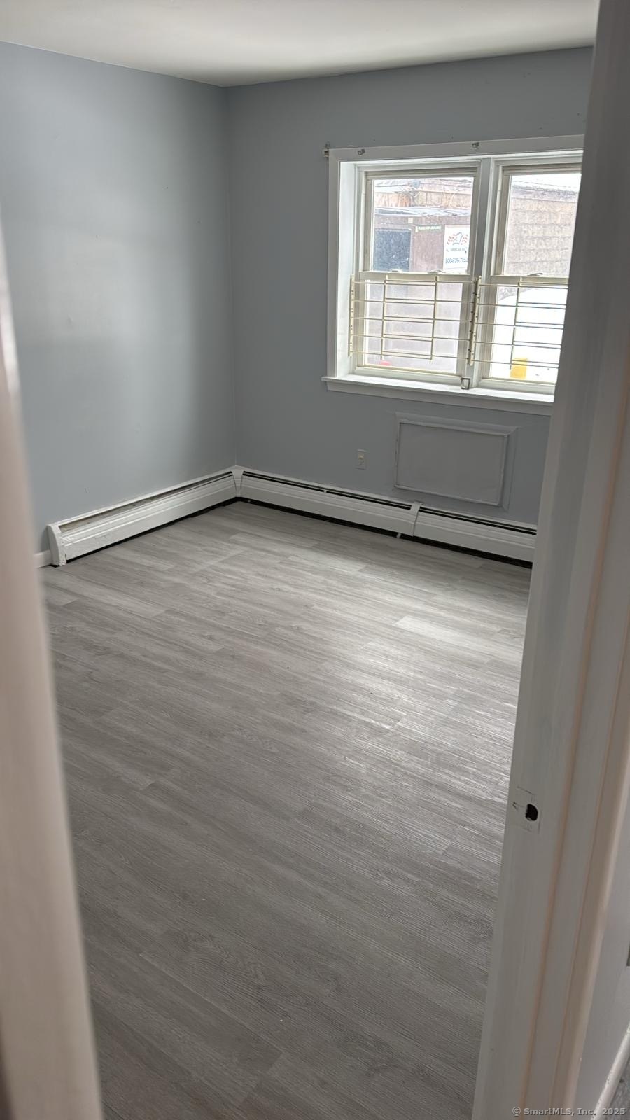 191 Oak Street, Unit B6 Bridgeport, CT 06604 - Photo 10 of 15 a view of an empty room with a window