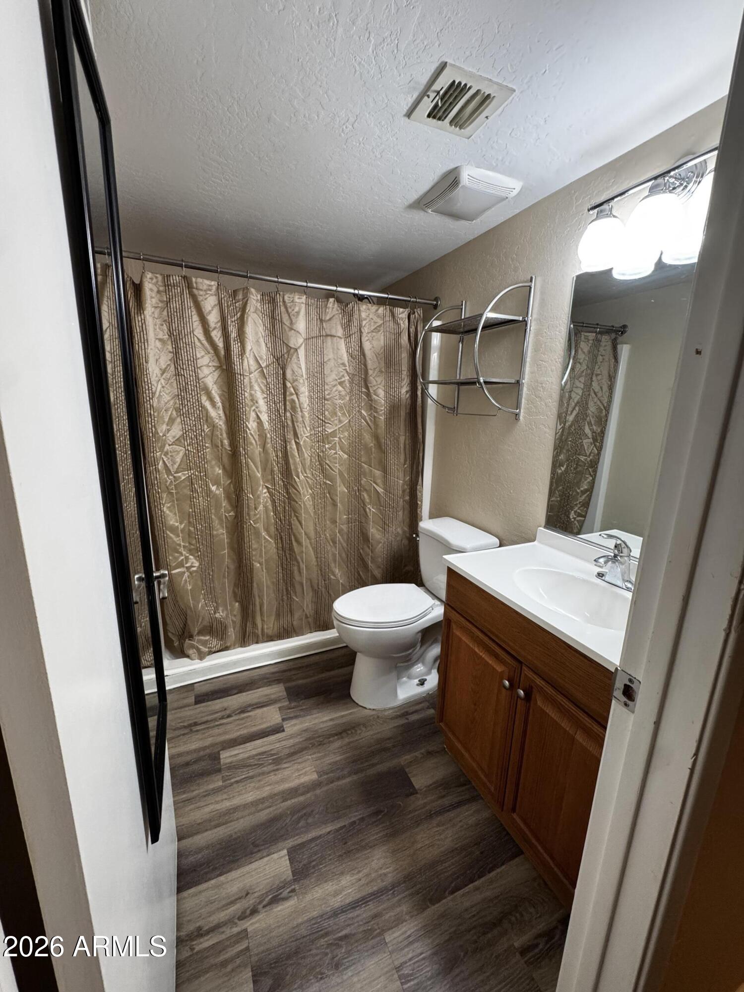 12123 West Bell Road, Unit 258 Surprise, AZ 85378 - Photo 10 of 30 a bathroom with a sink toilet and shower