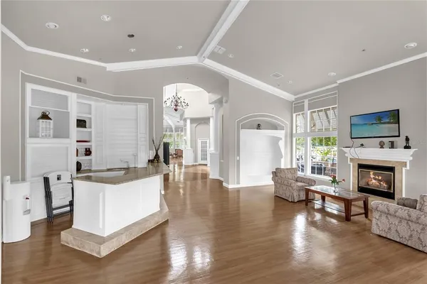 a living room with fireplace furniture and a wooden floor