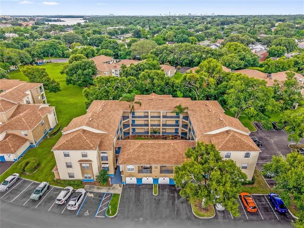 an aerial view of multiple houses with a yard