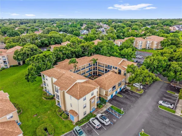 an aerial view of a house with a yard