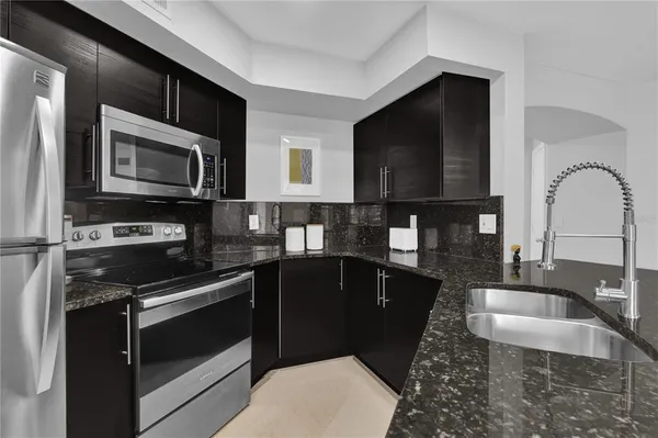 a kitchen with a sink stove and microwave