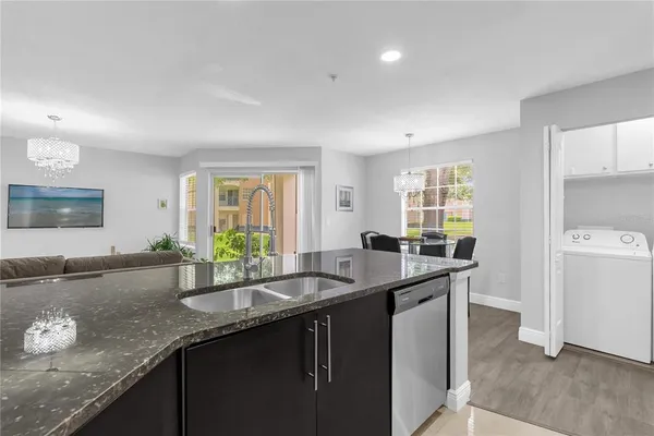 a kitchen with granite countertop a sink and a stove