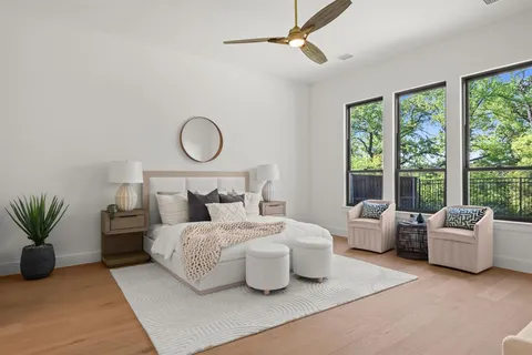 a bedroom with a bed and a large window