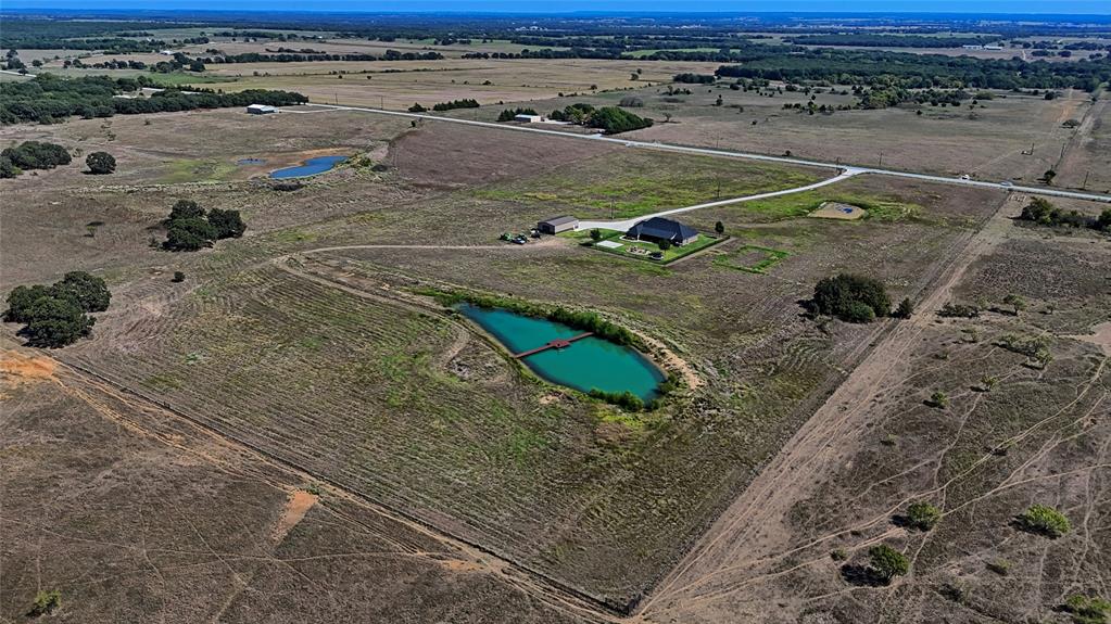 1150 Lone Star Road Bowie, TX 76230 - Photo 33 of 38 a view of a dry yard with wooden fence