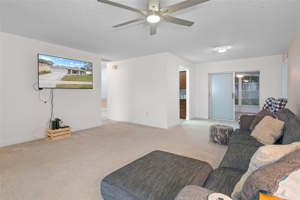 8130 Merrimac Drive Port Richey, FL 34668 - Photo 11 of 53 a living room with furniture and a lamp