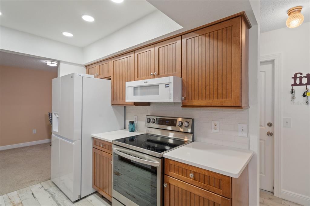 8130 Merrimac Drive Port Richey, FL 34668 - Photo 16 of 53 a kitchen with a stove and a refrigerator