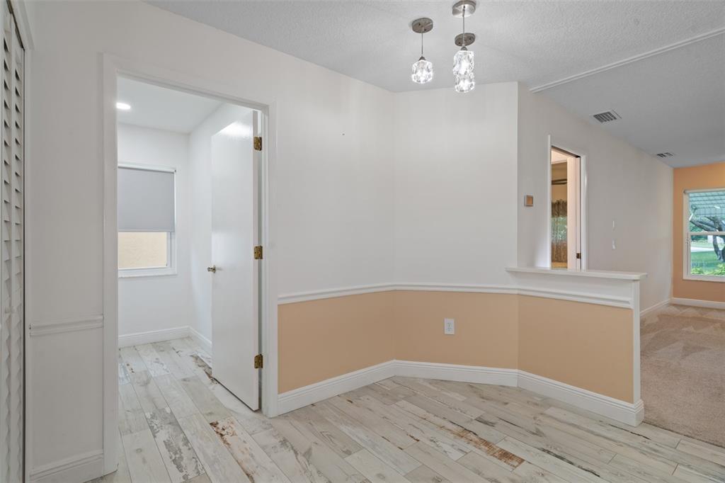 8130 Merrimac Drive Port Richey, FL 34668 - Photo 19 of 53 wooden floor in an empty room with a window
